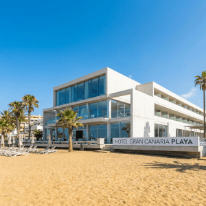 Hotel Gran Canaria Playa modern beachfront hotel with palm trees and empty sun loungers